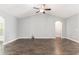 Spacious living room features vaulted ceiling, fan, and stylish dark wood floors at 5581 Plantersville Pl., Myrtle Beach, SC 29579