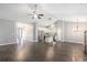 Spacious open-concept living area with hardwood floors, ceiling fans, and seamless flow to kitchen at 5581 Plantersville Pl., Myrtle Beach, SC 29579