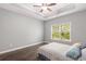 Main bedroom featuring a tray ceiling, fan, and window with views of the outdoors at 5581 Plantersville Pl., Myrtle Beach, SC 29579