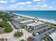 Aerial view shows the beautiful condos near the beach with pool, parking, palm trees, and ocean view at 5601 N Ocean Blvd. # C-106, Myrtle Beach, SC 29577