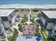 Aerial view of a condo community featuring a beautiful deck with seating and lush landscaping overlooking the beach at 5601 N Ocean Blvd. # C-106, Myrtle Beach, SC 29577