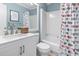 Cozy bathroom with a shower-tub combo, white vanity, and a stylish nautical-themed shower curtain at 5601 N Ocean Blvd. # C-106, Myrtle Beach, SC 29577
