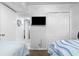 Clean bedroom with a TV and access to other rooms, offering functionality and relaxation for a comfortable living space at 5601 N Ocean Blvd. # C-106, Myrtle Beach, SC 29577