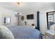 Cozy bedroom featuring beachy decor, a TV, and access to an outdoor space for relaxation at 5601 N Ocean Blvd. # C-106, Myrtle Beach, SC 29577