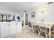 Open-concept dining area features a bright table setting, complemented by modern lighting and coastal decor at 5601 N Ocean Blvd. # C-106, Myrtle Beach, SC 29577