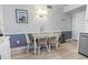 Comfortable dining area with natural light, featuring a stylish table setting and wall art at 5601 N Ocean Blvd. # C-106, Myrtle Beach, SC 29577