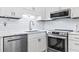 This open kitchen showcases modern stainless steel appliances, sleek white cabinets, and stylish subway tile backsplash at 5601 N Ocean Blvd. # C-106, Myrtle Beach, SC 29577