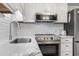 Modern kitchen features stainless appliances, marble countertops, and subway tile backsplash, perfect for cooking at 5601 N Ocean Blvd. # C-106, Myrtle Beach, SC 29577