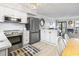 Cozy kitchen boasts stainless steel appliances, white cabinets, and a comfortable breakfast bar overlooking the living space at 5601 N Ocean Blvd. # C-106, Myrtle Beach, SC 29577