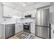 Bright kitchen features stainless steel appliances, subway tile backsplash, and a decorative anchor rug at 5601 N Ocean Blvd. # C-106, Myrtle Beach, SC 29577