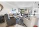Cozy living room features comfortable seating, stylish decor, and access to a balcony at 5601 N Ocean Blvd. # C-106, Myrtle Beach, SC 29577