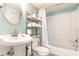 Well-maintained bathroom featuring a pedestal sink, updated fixtures, and a shower-tub combo at 5905 S Kings Highway # 6302, Myrtle Beach, SC 29575