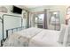 Bright bedroom featuring a sliding glass door to a balcony and stylish nautical decor at 5905 S Kings Highway # 6302, Myrtle Beach, SC 29575