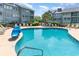 Resort-style pool surrounded by lounge chairs, perfect for relaxation at 5905 S Kings Highway # 6302, Myrtle Beach, SC 29575
