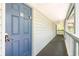 Exterior view of a hallway and front door with blue painted door and white siding at 5905 S Kings Highway # 6302, Myrtle Beach, SC 29575
