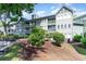 Inviting light blue multi-story building with balconies, landscaping and a swing at 5905 S Kings Highway # 6302, Myrtle Beach, SC 29575