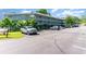 A three-story building with balconies and ample parking space with several parked cars and green landscaping at 5905 S Kings Highway # 6302, Myrtle Beach, SC 29575