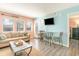 Comfortable living room featuring stylish decor, a mounted television, and ample natural light at 5905 S Kings Highway # 6302, Myrtle Beach, SC 29575