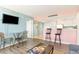Comfortable living room featuring stylish decor, breakfast bar, and mounted television at 5905 S Kings Highway # 6302, Myrtle Beach, SC 29575