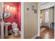 A half bathroom featuring a decorative mirror and sconces, next to a bedroom at 6001-T36 South Kings Hwy., Myrtle Beach, SC 29575