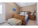A bedroom with carpet, a bed, bedside table, and an ottoman at 6001-T36 South Kings Hwy., Myrtle Beach, SC 29575