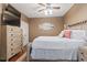 A well-lit bedroom showcasing beach-themed decor, a ceiling fan, and a dresser at 6001-T36 South Kings Hwy., Myrtle Beach, SC 29575