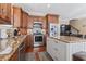 Well-equipped kitchen with stainless steel appliances, custom cabinets, granite countertops, and center island for meal prep at 6001-T36 South Kings Hwy., Myrtle Beach, SC 29575