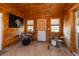 Unique bonus room featuring a dart board and drum set. The space is enhanced by wood walls and windows at 602 Six Lakes Dr., Myrtle Beach, SC 29588