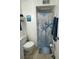 Charming bathroom featuring beach-themed decor, a shower, and organized towel storage at 609 Hillside Dr. S # C-10, North Myrtle Beach, SC 29582