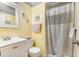 Bright bathroom featuring a white vanity, toilet, and shower with beach-themed accents at 609 Hillside Dr. S # C-10, North Myrtle Beach, SC 29582