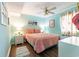 Cozy bedroom with a ceiling fan, complemented by soft lighting and beach-themed decor at 609 Hillside Dr. S # C-10, North Myrtle Beach, SC 29582