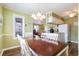 Dining area adjacent to kitchen, featuring wood table, seating for six, chandelier at 609 Hillside Dr. S # C-10, North Myrtle Beach, SC 29582