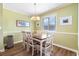 A cozy dining room features a wood table, seating for six, and lots of light at 609 Hillside Dr. S # C-10, North Myrtle Beach, SC 29582