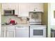 Bright kitchen with stainless steel microwave, white cabinets, and white appliances at 609 Hillside Dr. S # C-10, North Myrtle Beach, SC 29582