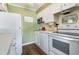 A bright kitchen with white cabinets, light countertops, and modern appliances at 609 Hillside Dr. S # C-10, North Myrtle Beach, SC 29582