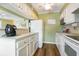 A bright kitchen with white cabinets, light countertops, and modern appliances at 609 Hillside Dr. S # C-10, North Myrtle Beach, SC 29582