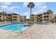 Inviting pool area with brick pavers, palm trees, and community buildings in the background at 609 Hillside Dr. S # C-10, North Myrtle Beach, SC 29582