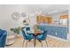 Dining area with round table, blue velvet chairs and statement lighting adjoining the kitchen at 6253 Catalina Dr. # 1533, North Myrtle Beach, SC 29582