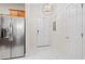 Welcoming entryway with modern lighting, stainless steel fridge and white tile floors at 6253 Catalina Dr. # 1533, North Myrtle Beach, SC 29582