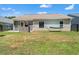 Spacious backyard with a stone grill, a hammock, and lush lawn, perfect for outdoor living at 6485 Royal Pine Dr., Myrtle Beach, SC 29588
