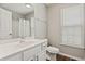 Bright bathroom featuring a white vanity, a large mirror, and natural light from the window at 6485 Royal Pine Dr., Myrtle Beach, SC 29588