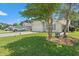 Quaint home showcasing a landscaped front yard with mature trees and a spacious two-car garage at 6485 Royal Pine Dr., Myrtle Beach, SC 29588