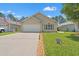 Well-maintained single-story home with a neat lawn and a driveway leading to a two-car garage at 6485 Royal Pine Dr., Myrtle Beach, SC 29588