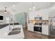 Stylish kitchen showcasing white cabinetry, stainless steel appliances, and an island with a double sink at 6485 Royal Pine Dr., Myrtle Beach, SC 29588