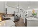 Modern kitchen featuring stainless steel appliances, white cabinets, and a spacious island with seating at 6485 Royal Pine Dr., Myrtle Beach, SC 29588