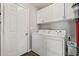 Functional laundry room with white washer and dryer, ample storage, and clean finishes at 6485 Royal Pine Dr., Myrtle Beach, SC 29588