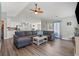 Spacious living room connected to the kitchen, featuring a large sectional sofa and hardwood floors at 6485 Royal Pine Dr., Myrtle Beach, SC 29588