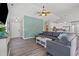 Open-concept living room with a large sectional sofa, modern fireplace, and decorative ceiling fan at 6485 Royal Pine Dr., Myrtle Beach, SC 29588