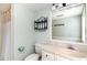 Clean bathroom features a toilet, sink, mirror, and shower with a curtain at 668 S Waccamaw Dr., Murrells Inlet, SC 29576