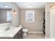 Bathroom featuring a vanity, toilet, a window and a stacked washer and dryer at 668 S Waccamaw Dr., Murrells Inlet, SC 29576